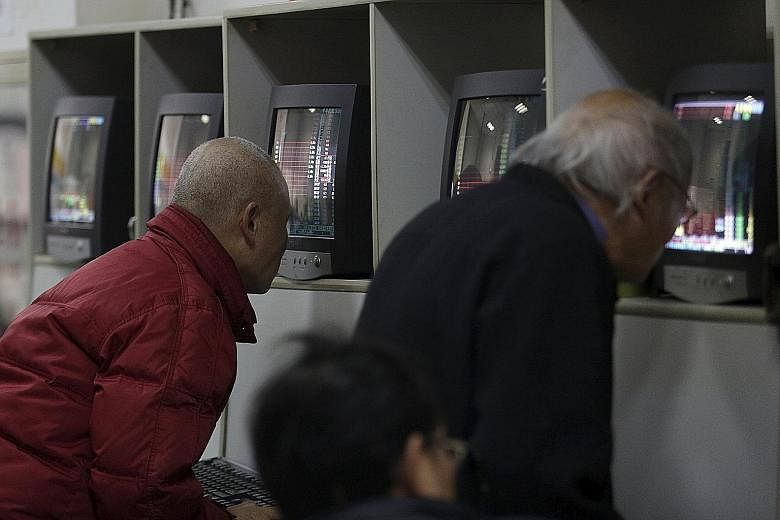 Investors checking stock prices at a brokerage house in Shanghai on Friday. What is worrying investors is the Chinese central bank's vacillating attitude on the yuan..