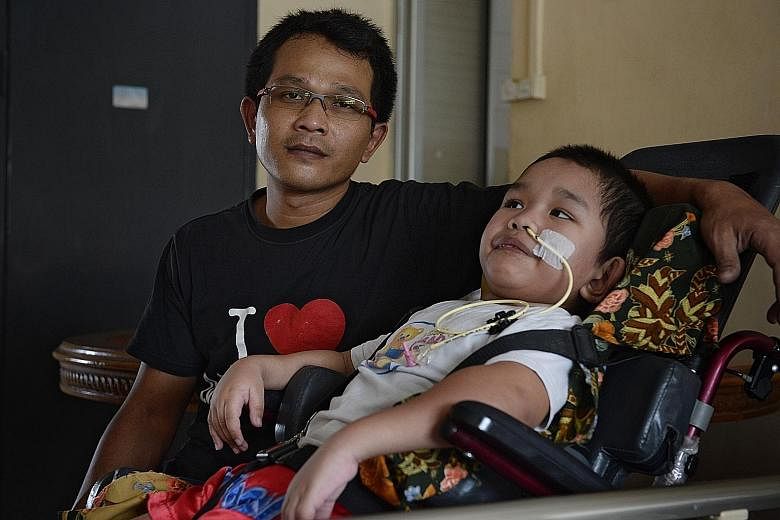 Mr Abdul Halim with his son Syahriz, who spent the last three months warded at KK Women's and Children's Hospital.