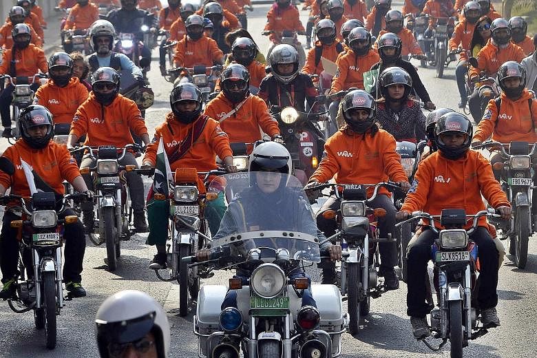 Participants of Women on Wheels (WOW) riding their motorcycles during a rally launching the campaign in Lahore, Pakistan, on Sunday. A new wave of female drivers in Pakistan is pushing the boundaries set by men in a deeply conservative Muslim country