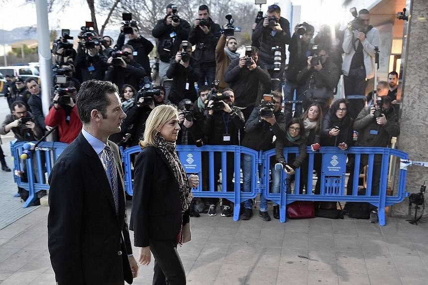Princess Cristina and her husband Inaki Urdangarin arriving at court on the island of Majorca yesterday. Cristina has been charged with tax evasion while her husband is accused of embezzlement, influence peddling, document falsification, money launde