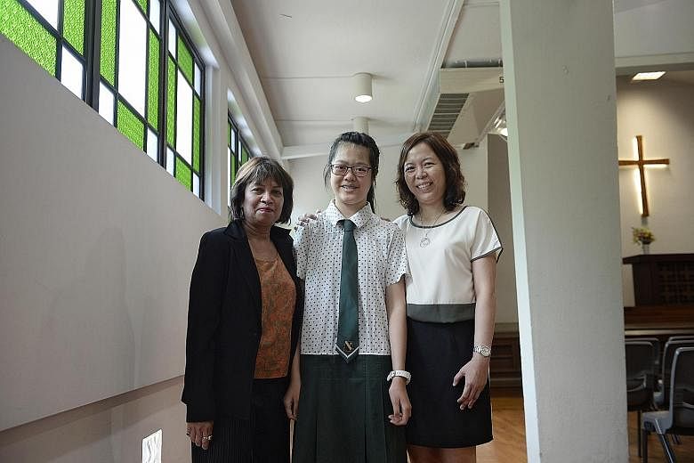 Janessa Yu with her English teacher Shamini Rajandran and Chinese teacher Florence Chang at St Margaret's Secondary School yesterday. Janessa has Charcot-Marie-Tooth disease, which causes a gradual loss of muscle tissue and sense of touch.
