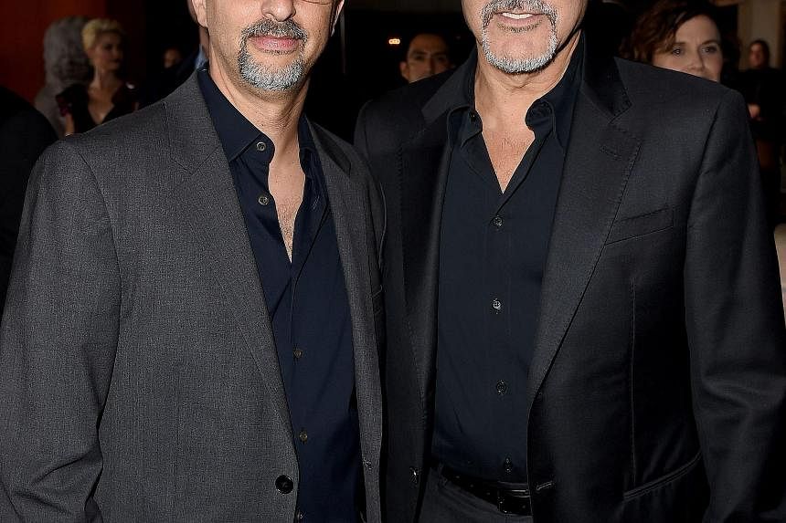 Film producers Grant Heslov (left) and George Clooney developed the story behind Our Brand Is Crisis.