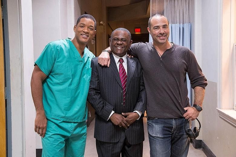 (From left) Actor Will Smith with the real Bennet Omalu whom he portrays in Concussion, and director Peter Landesman. The doctor wants to manage risks in high-impact as well as limited contact sports.
