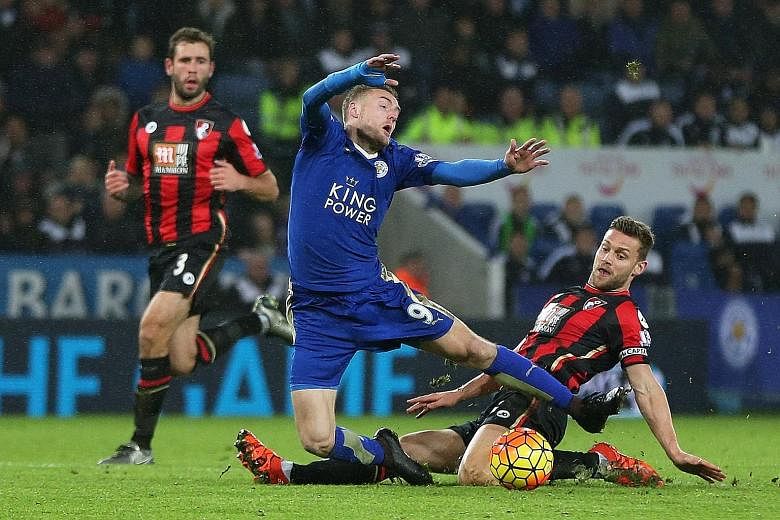 Jamie Vardy (left) being fouled by Bournemouth's Simon Francis, who was sent off. But Leicester missed the penalty and the game ended 0-0.