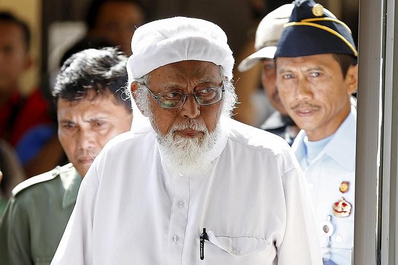 Abu Bakar Bashir, widely seen as the spiritual leader of JI, entering the courthouse in Cilacap, Central Java, yesterday.