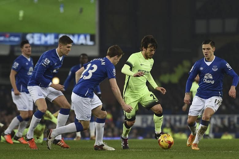 City's David Silva (on the ball) being challenged by Everton's Muhamed Besic (right) and Seamus Coleman in the League Cup semi-final first leg which Everton won 2-1.