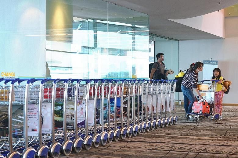 Travellers arriving in Singapore (left). Those who use the Customs@SG app (above) can exit the checkpoint through the Customs Green Channel without having to stop to declare and pay the duty/GST for the goods at the Customs Tax Payment Office.
