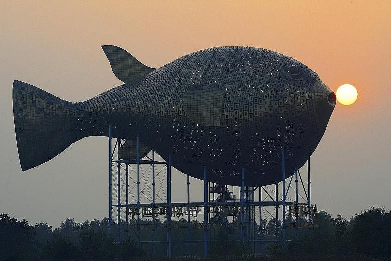 A giant puffer fish, on the banks of a river in Yangzhong county, China's Jiangsu province, is encased in 8,920 copper plates and was built at a cost of around 70 million yuan (S$15 million). Trade data released yesterday showed China's copper import