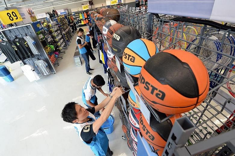 Decathlon staff preparing for the store's opening on Saturday in Viva Business Park in Chai Chee. The French sporting goods retailer signed a lease for more than 15 years for the 35,000 sq ft outlet.