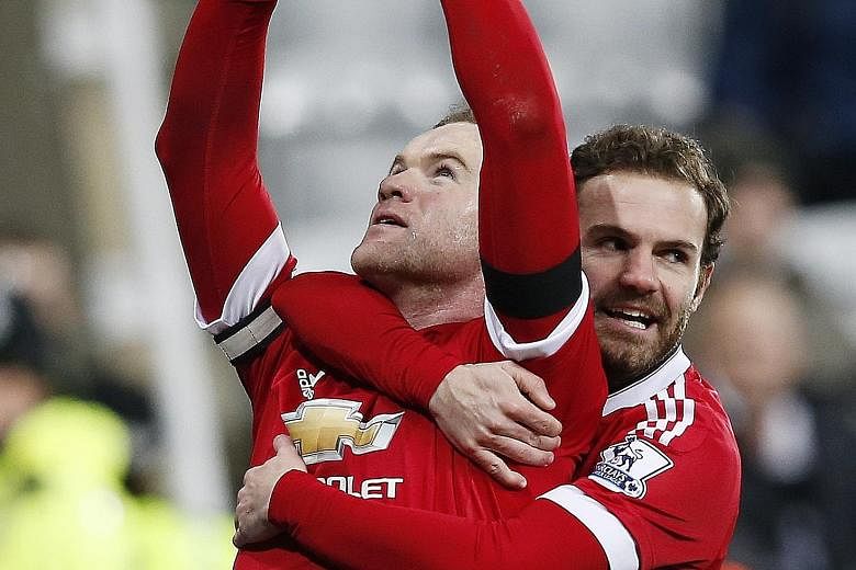 Wayne Rooney celebrating with Juan Mata after scoring the third goal for Manchester United against Newcastle.