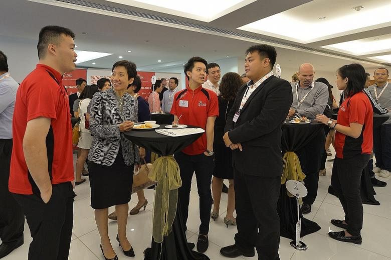 Minister for Culture, Community and Youth Grace Fu (second from left) with Team Singapore athletes (in red polo shirt) Peter Kam and Shayna Ng at yesterday's launch of the spexEntrepreneurship programme.