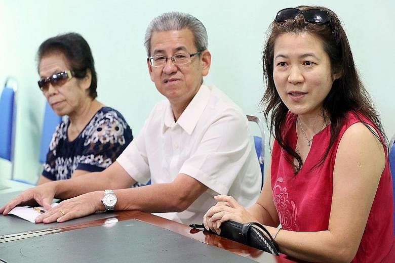 At a press conference last week, Singaporean Cannie Wong (right) said she adopted Angie through a middleman. With her are businessman Yap Yeen Min, who helped arrange the meeting, and her mother-in-law. Angie Tiong with a Malaysian social worker. Ang