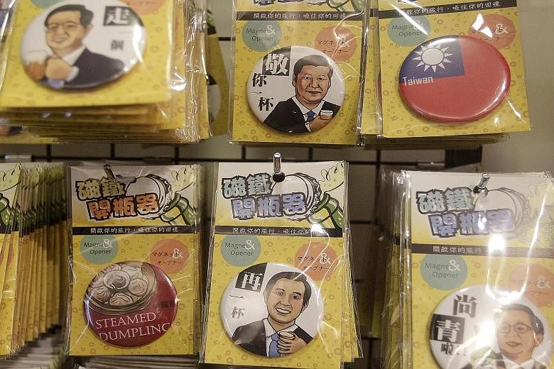 Souvenirs depicting China's Mr Xi and Taiwan's Mr Ma on display at a gift shop in Taipei. Should Ms Tsai Ing-wen of the pro-independence Democratic Progressive Party become Taiwan's President, China could turn off economic concessions, such as stoppi