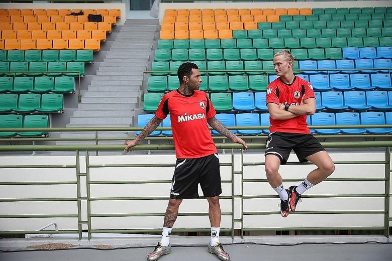 Jermaine Pennant (left) chats with Dane Philip Lund, who is also on trial with the Stags. Tampines have been able to meet Pennant's wage demands thanks to sponsor Komoco Motors, which will fund part of his salary.