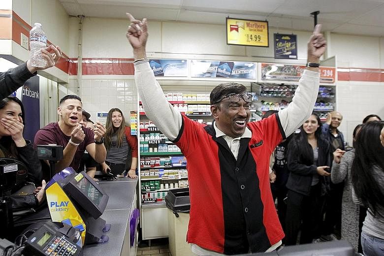 Mr M. Faroqui, a 7-Eleven employee in Chino Hills, California, celebrating on Wednesday after finding out that the store had sold one of the winning Powerball tickets. The store will receive a US$1 million bonus, lottery officials said. Wednesday's j
