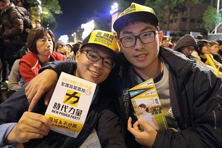 Students Ou Ming (left), 22, and Lin Chia-hsien, 21, at a rally for the New Power Party in Taiwan. "We need a party that tilts left, one that cares about the people," says Mr Lin.