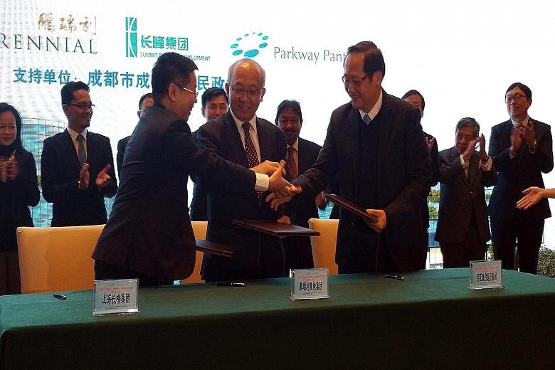 (From left): Mr Wang Weichao, president and general manager of Shanghai Summit's Chengdu office, Mr Pua Seck Guan, Perennial Real Estate Holdings CEO, and Dr Tan See Leng, Parkway Pantai group CEO, signing the lease yesterday to set up Parkway Health