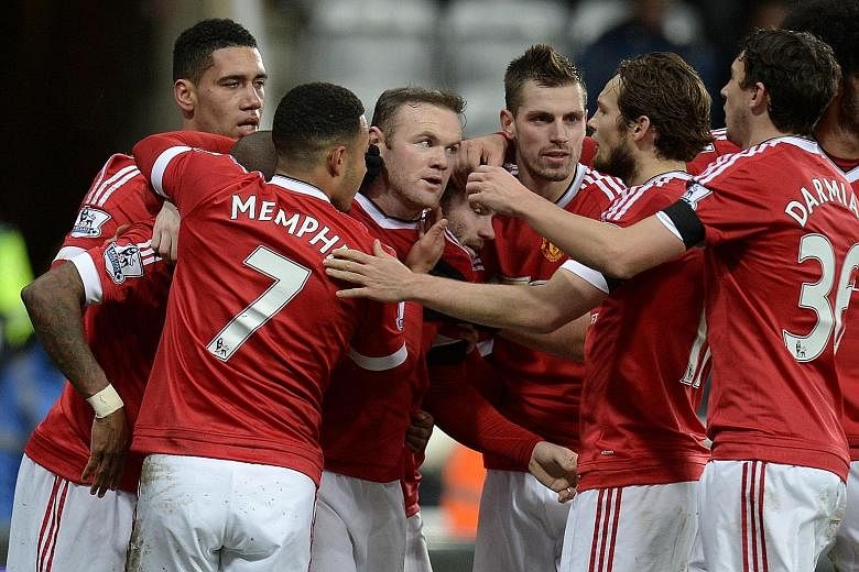 Wayne Rooney (third from left) celebrating with team-mates after netting for United against Newcastle. Liverpool also drew 3-3 in midweek. It remains to be seen if both sides will continue their goal rush.