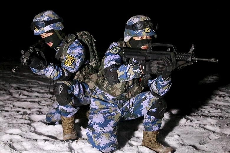 PLA marines training in the Xinjiang Uighur Autonomous Region on Jan 11, days after China passed a new law that permits its military to venture overseas on counter-terror operations.