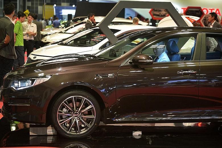 Potential car buyers and enthusiasts viewing the displays at the Singapore Motorshow 2016 at Suntec Convention and Exhibition Centre on Thursday. Sales at car showrooms surged 59.7 per cent in November compared with the same month in 2014, as consume