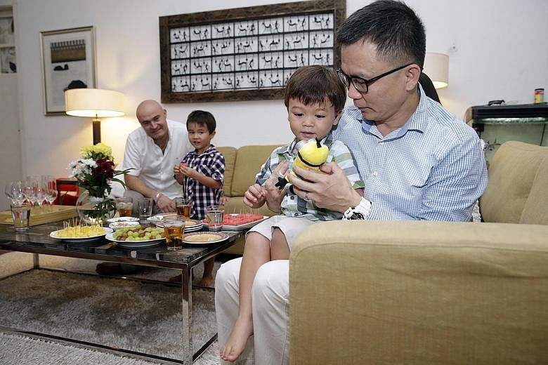 Dr Low Lee Yong hands Adam a toy as Mr Christophe Cabibel and older son Louis look on. Adam had suffered a febrile fit while on a flight back from France and passed out. Dr Low attended to and revived him. The Cabibels met Dr Low yesterday at their P