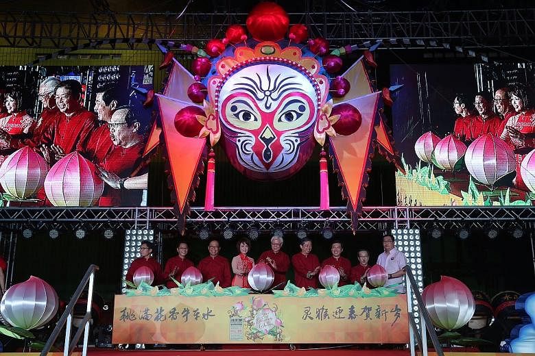 The Chinatown Chinese New Year celebrations opened with drum performances (left) and acrobatic shows. Launching the light-up were (below, from left) Mr Kenneth Lim of the Singapore Tourism Board; Mr Peh Cheng Hoo, co-chairman of the celebrations' org