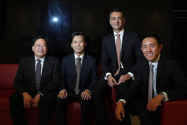 Helping to build the customised investment portfolios in the new Save and Invest Portfolio series are (from left) Mr Phoon Chiong Tuck, Mr Jack Wang, Mr Praveen Jagwani and Mr Simon Ng.