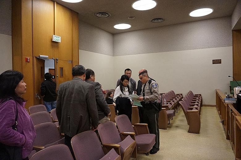 A court bailiff giving former Stanford student Ouyang Xiangyu instructions after her sentencing. She pleaded "no contest" to four counts of poisoning her former laboratory mates at the university.