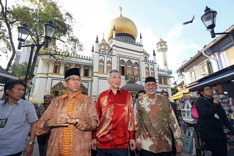 Prime Minister Lee Hsien Loong and Dr Yaacob Ibrahim joining Mr Mohamed Patail (right, in photo at left) at Sultan Mosque yesterday for an event to mark the completion of its upgrading. New features for the mosque, gazetted a national monument in 197