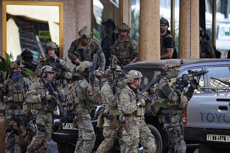 French forces outside the Splendid hotel in Ouagadougou, Burkina Faso, yesterday. People from 18 countries were rescued from the site of the attack duringan operation that received support from French and United States forces.