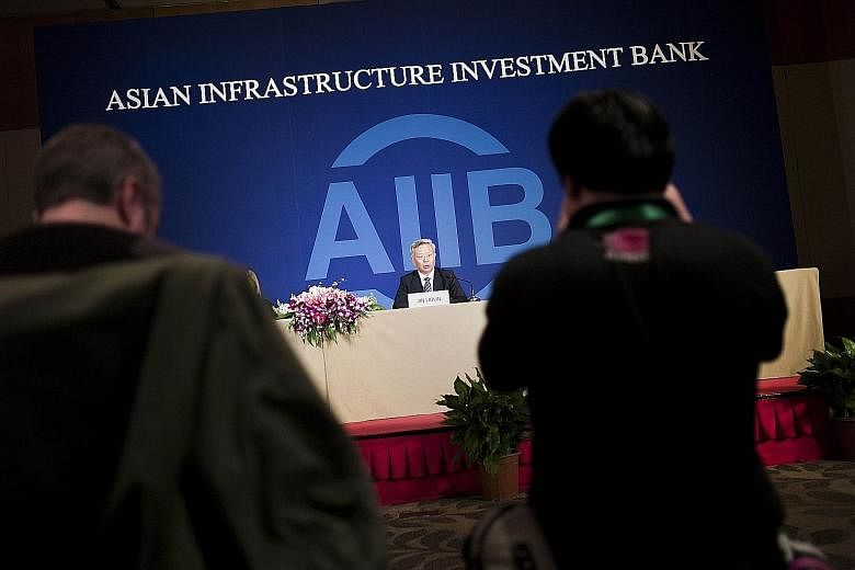 AIIB president Jin speaking to journalists in Beijing yesterday. His pledge comes amid concerns that the AIIB might fail to keep global standards in environmental, labour and anti-corruption protection.
