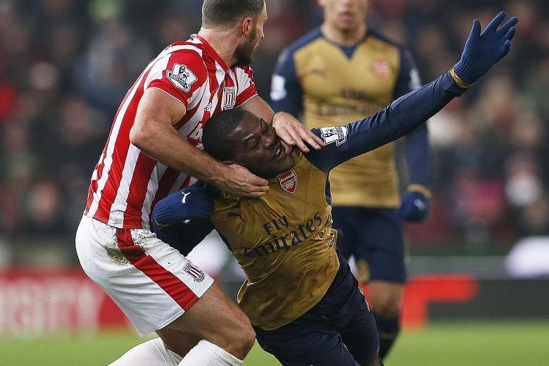 Arsenal's Joel Campbell (in gold) challenging for the ball with Stoke's Erik Pieters during the 0-0 draw on Sunday.