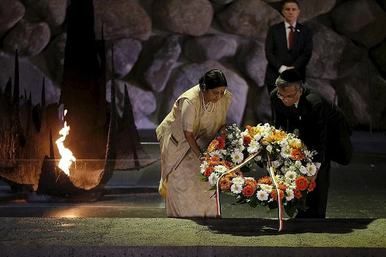 Indian External Affairs Minister Sushma Swaraj and India's ambassador to Israel Jaideep Sarkar laying a wreath during a ceremony in the Hall of Remembrance at the Yad Vashem Holocaust Memorial in Jerusalem yesterday.
