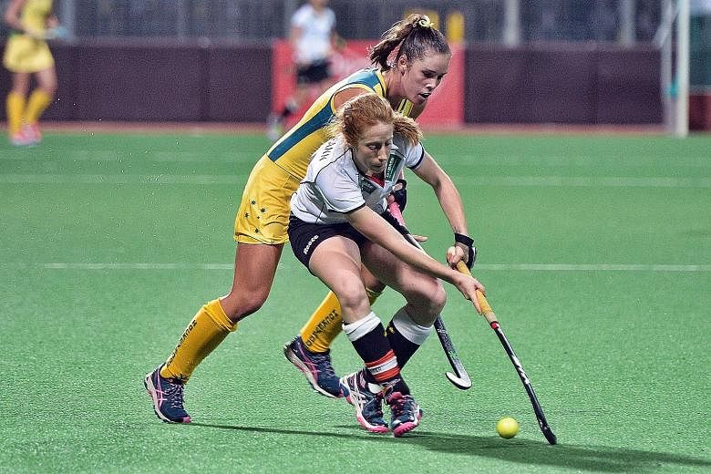 Australia's Grace Stewart (behind) squaring off with Germany's Nina Hasselmann during the 1-1 draw in the opening match of the International Tri-Series tournament at Sengkang Stadium. Germany face world and Olympic champions the Netherlands today.