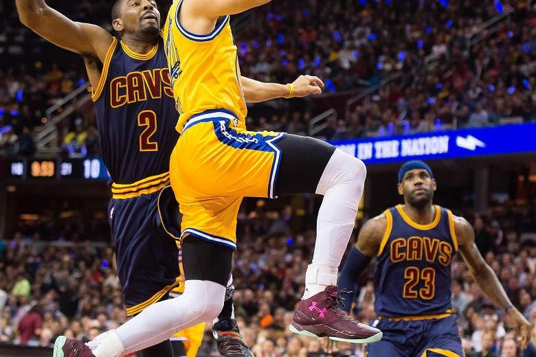 Golden State's Stephen Curry shooting over Cleveland's Kyrie Irving as LeBron James looks on. The 132-98 thrashing in the re-match of last year's NBA Finals saw the Warriors improve to 38-4 for the season while the Cavaliers went to 28-11. The 34-poi