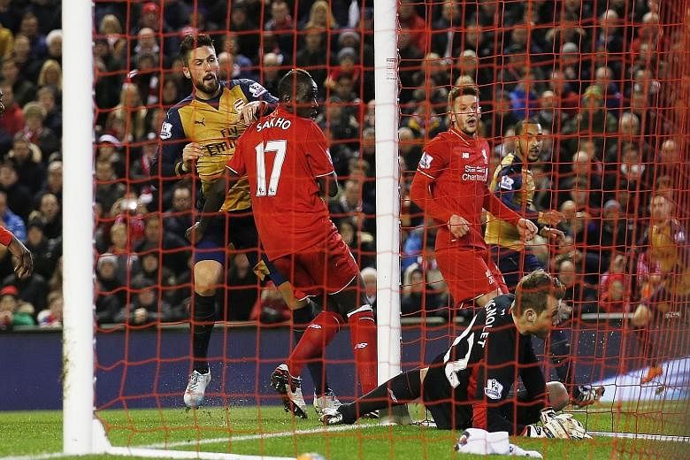 Simon Mignolet is beaten at his near post by Olivier Giroud's (left) poke from a corner during the recent draw with Arsenal. The Liverpool 'keeper has been handed a new contract despite the odd scrappy performance.