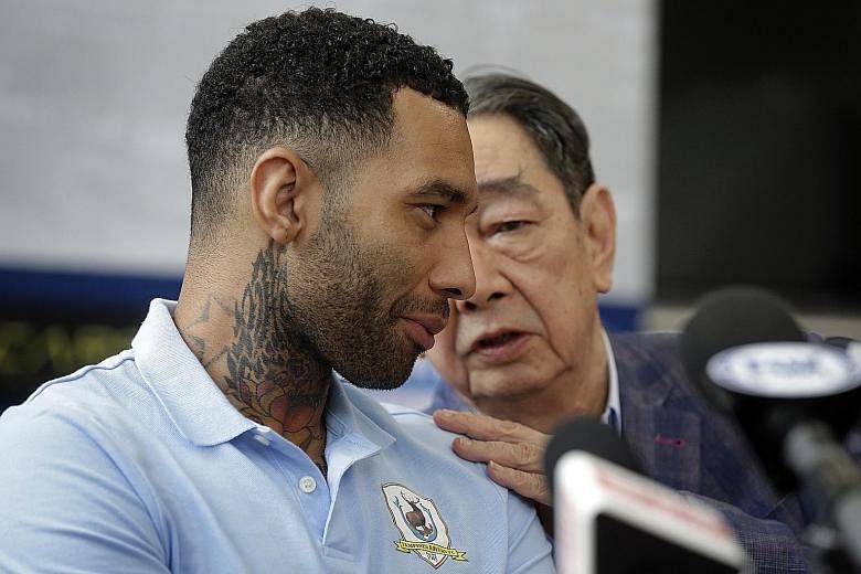 Jermaine Pennant having a chat with former Tampines Rovers chairman Teo Hock Seng, who presented the player with the club's No. 9 jersey yesterday. The former Arsenal and Liverpool winger has indicated that he is willing to stay on in Singapore if th