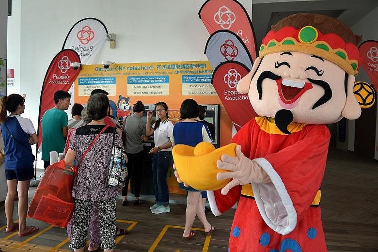 The queues atthe pop-up ATMs in Ci Yuan Community Club yesterday. Customers can use their DBS/POSB ATM cards to withdraw notes in sums of $100, $300 and $500, up to their individual card limit at these machines.