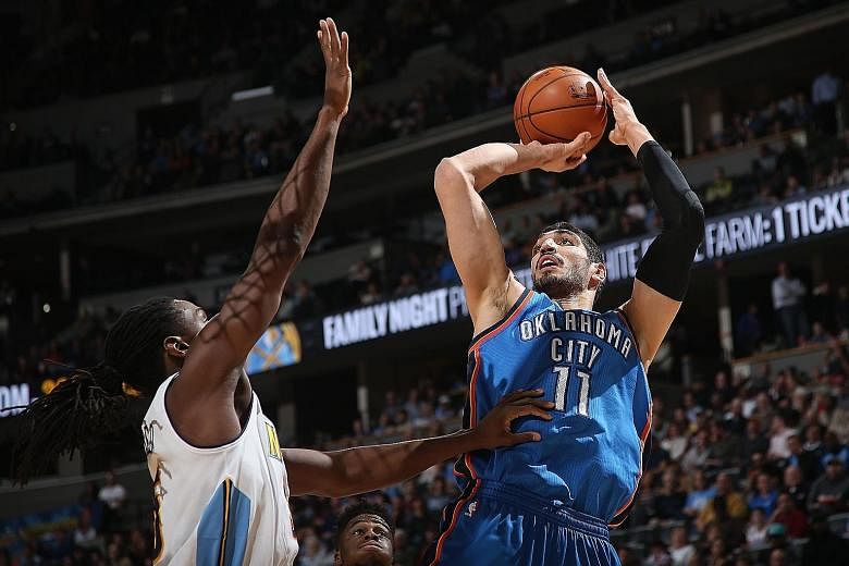 Oklahoma City's Enes Kanter (right) taking a shot over Denver's Kenneth Faried at the Pepsi Centre. The Thunder defeated the Nuggets 110-104.