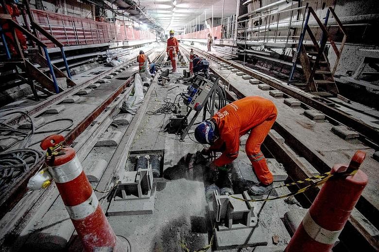 Workers on duty at part of Line 4, which is still being built. It will reach the Western part of Rio, where the Olympic Village and many of the competitions are based. Works are 83 per cent complete.