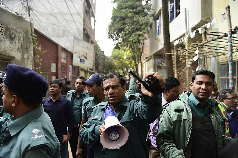 Bangladeshi police officials securing the area after a raid on a building housing suspected militants in Dhaka last month.