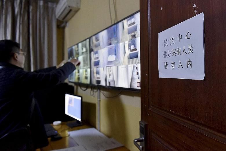 Officers look at monitors inside a surveillance room at a holding centre of the People's Procuratorate of Sichuan province for officials suspected of corruption. Critics say there is a lack of transparency around China's anti-graft drive and that it 