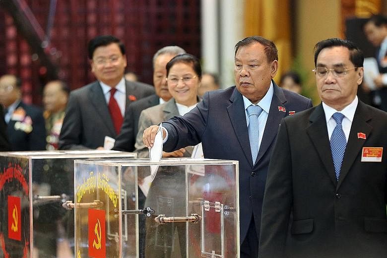 The Vice-President of Laos, Mr Bounnhang Vorachit, casting his ballot during the Communist Party congress in Vientiane. The 78-year-old was chosen yesterday to be the new leader of the highly secretive party.