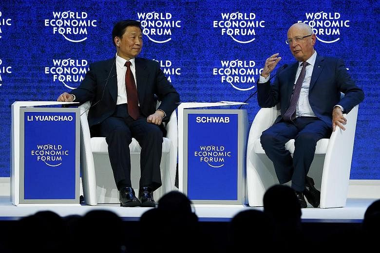 World Economic Forum executive chairman and founder Klaus Schwab speaking with Chinese Vice-President Li Yuanchao during the annual meeting of the forum in Davos, Switzerland, on Thursday.