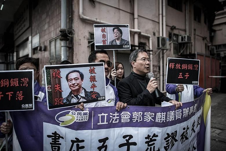 Members of the Civic Party staging a protest over the missing booksellers outside China's liaison office in Hong Kong on Tuesday. Activists are calling on Hong Kong leader Leung Chun Ying to better defend what seems to be an increasingly troubled "on