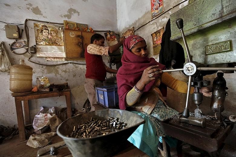 Labourers in small factories, such as this one in Faridabad, often toil for 12 hours a day to make parts for firms like Honda Motor and Yamaha Motor. PHOTO: REUTERS