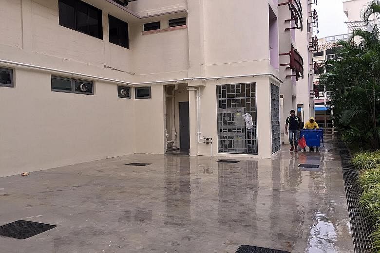 The space where the life pack was set up by SCDF officers (top left). The man could be seen on the ledge of the 12th-floor flat (above) before he fell to his death.