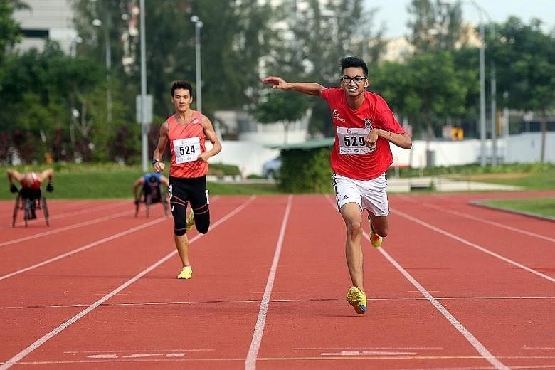Singapore para-athletes Lionel Toh (right) and Zac Leow competing in the 200m race of the Singapore Athletics Track and Field Series One yesterday. A total of 11 para-athletes signed up for the event, held at the Kallang Practice Track. Some 700 are 