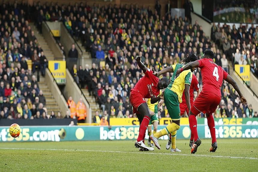 Clockwise from top: Adam Lallana celebrating by jumping onto Juergen Klopp after scoring Liverpool's fifth goal. The backheel opener from Norwich's Dieumerci Mbokani. Roberto Firmino on the double with the third goal for Liverpool.