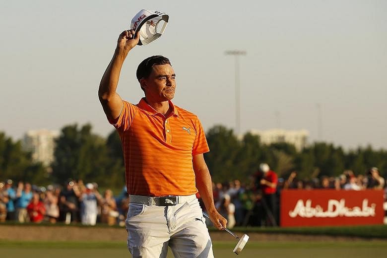 Rickie Fowler smiles after winning the Abu Dhabi HSBC Championship, his fourth title in eight months.